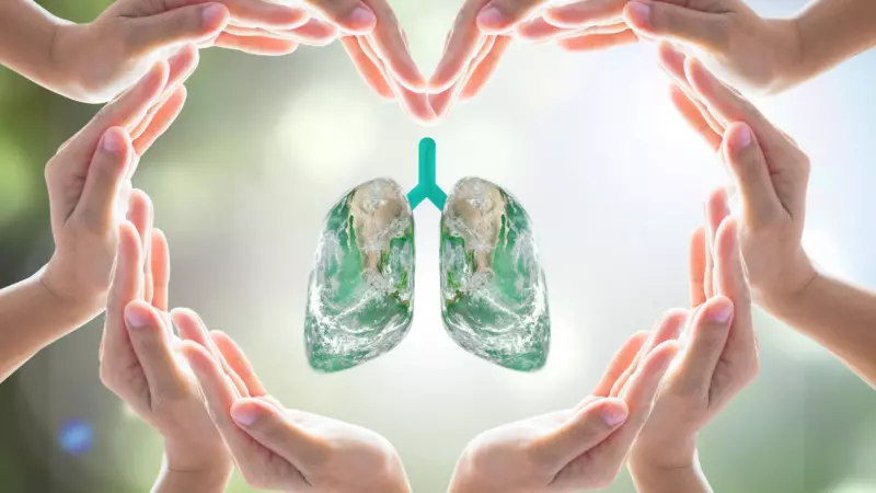 Artistic image of lung surrounded by hands