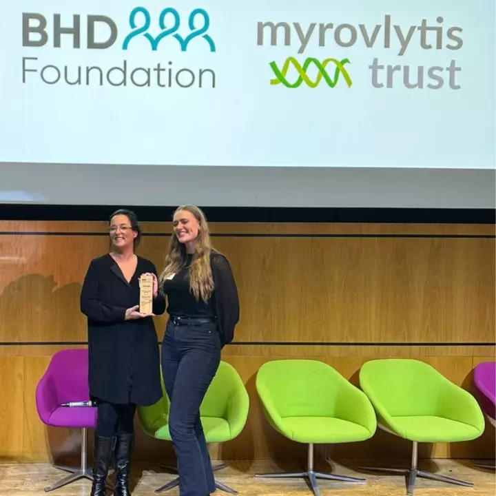 Myrovlytis Trust CEO Alison Taylor (left) presents Jennifer Hertiz with her Dr Anna Webb Award for Best Early Career Researcher at the BHD Symposium in London, October 2023